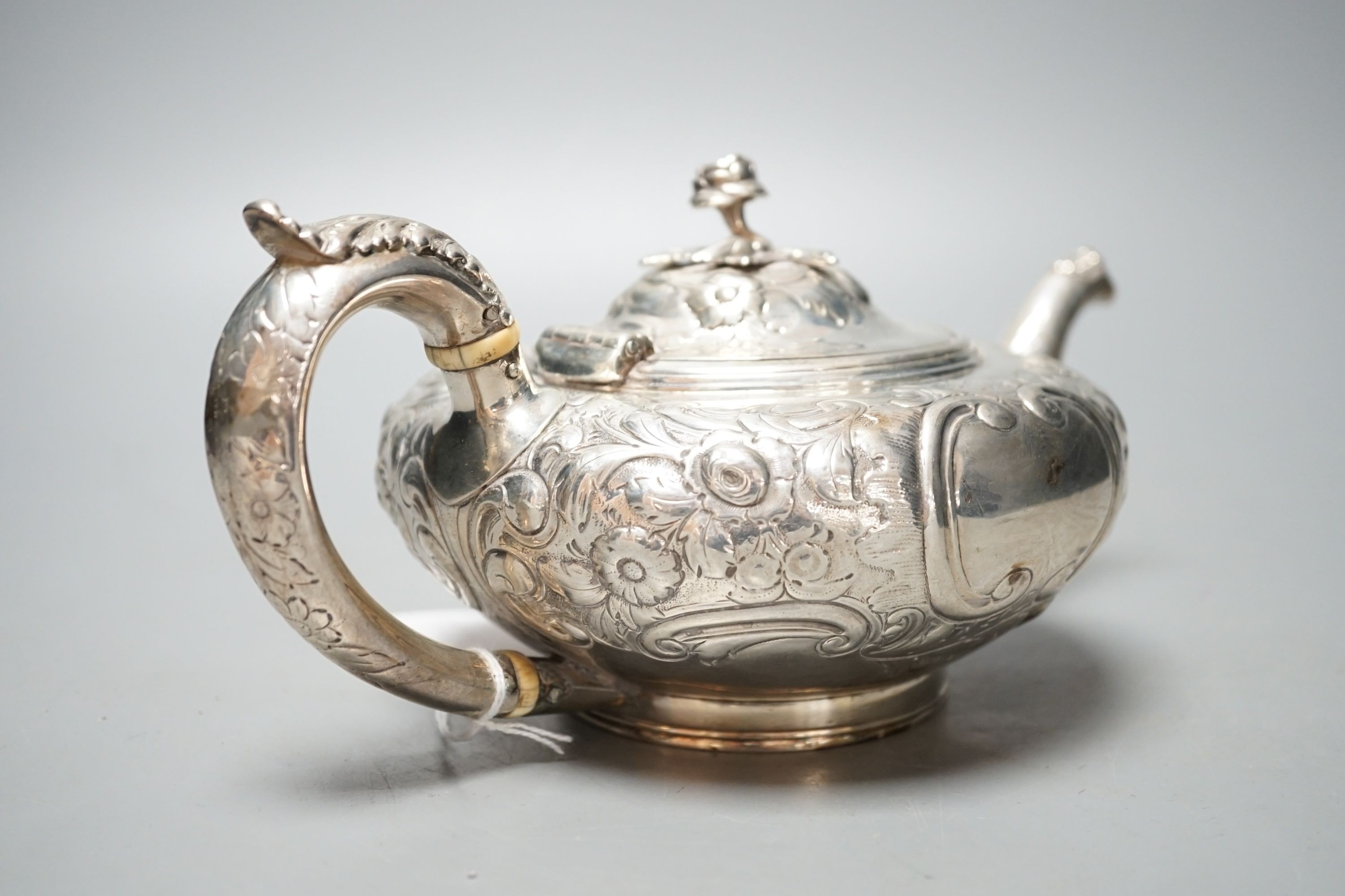 A Victorian embossed silver teapot, Walter Morrise, London, 1842, gross 15.5oz.